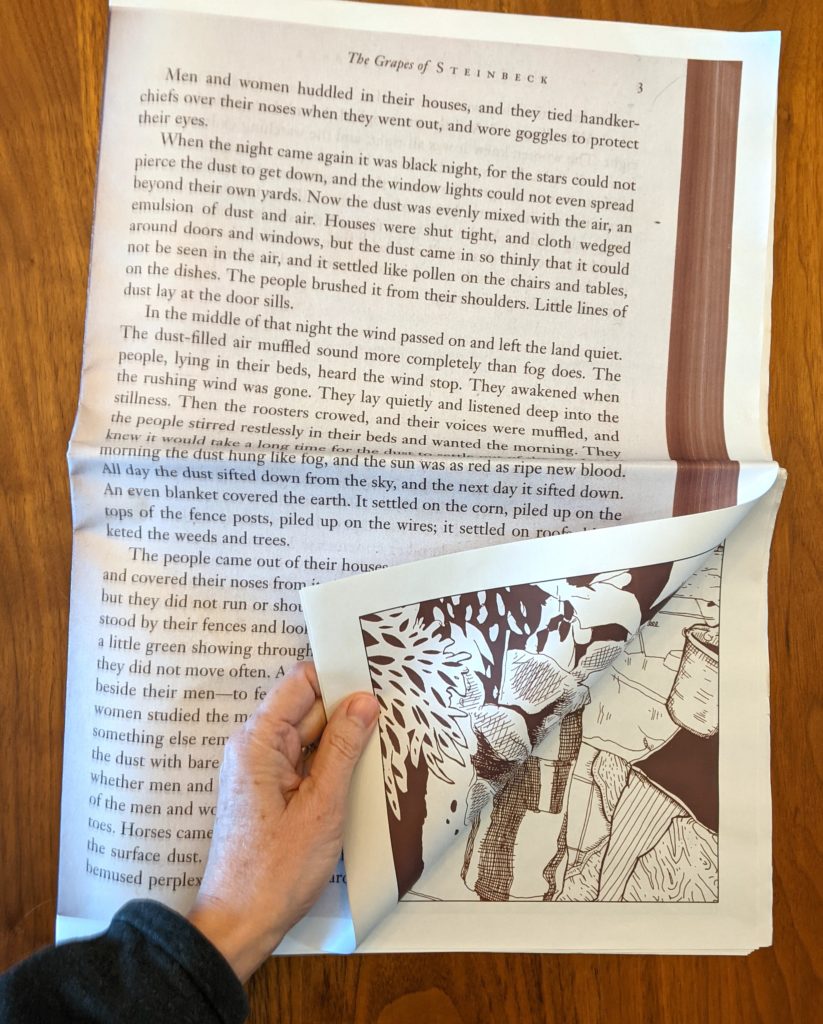A hand is seen turning the page on Juan Cisnero's newspaper titled Grapes of Steinbeck. The pages are off-white and the ink is brown. The page being turned has printed text on the facing side but comic images are revealed as the page is turned to the paper's inside surfaces.