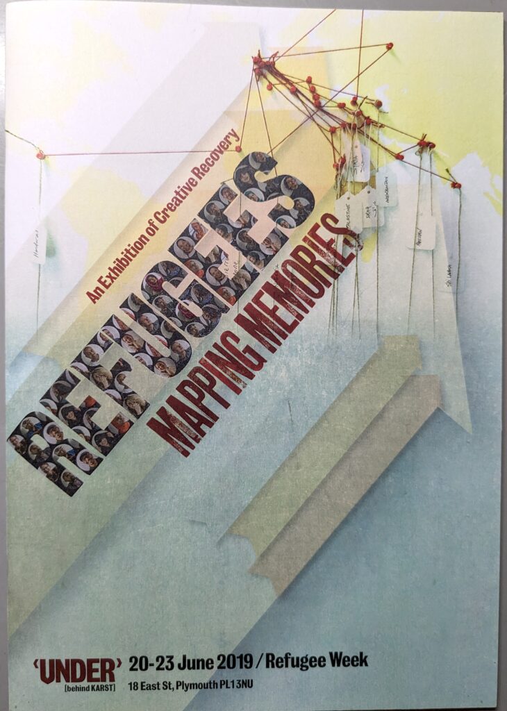 The cover of the exhibition brochure "Refugees Mapping Memories" that includes a stylized picture of red pushpins holding intersecting red strings with notes attached to each point.