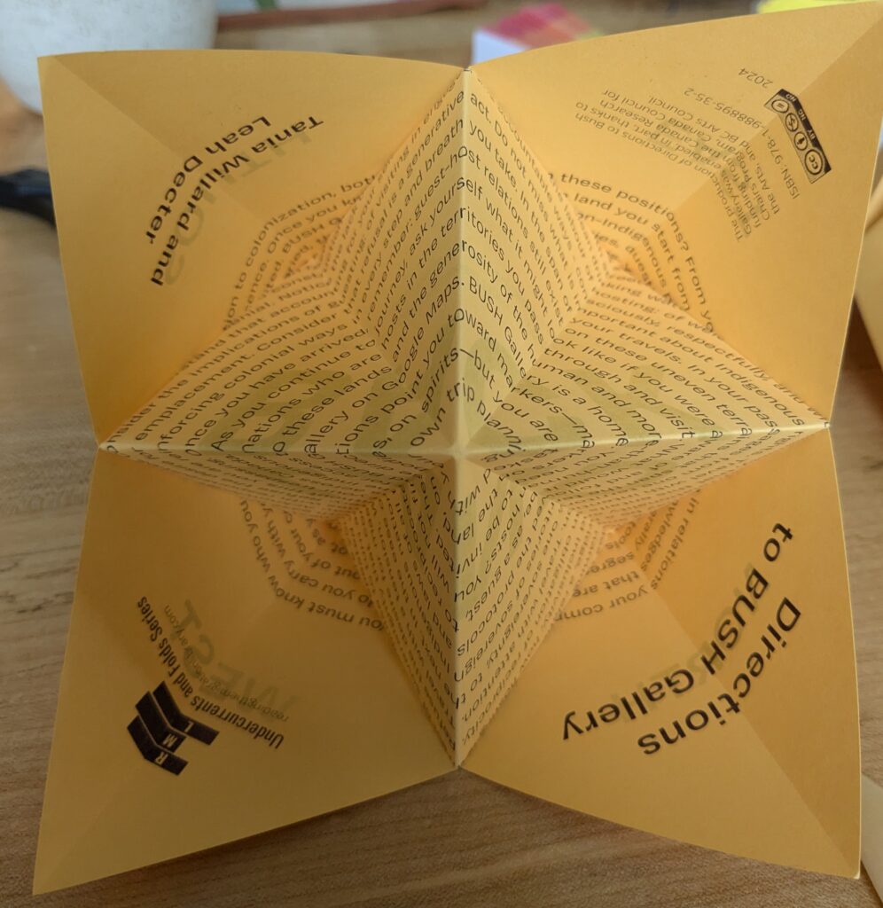 An inside view of the folded "fortune teller" sheet that is part of Directions to BUSH Gallery by Tania Willard and Leah Decter. The fortune teller is printed in dark purple ink on goldenrod yellow paper. There is a spiral text visible from the inside.