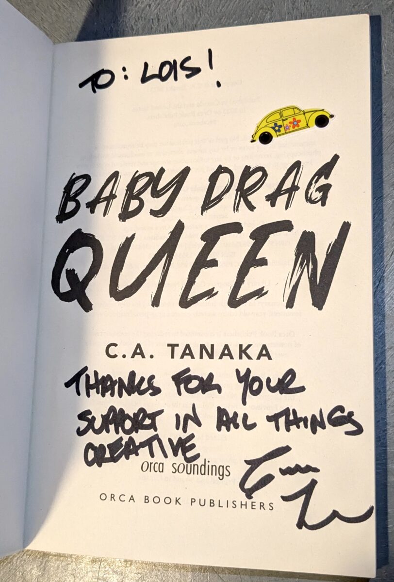 The inside cover of Baby Drag Queen by Candie Tanaka has an inscription and signature as well as a glittery sticker of a yellow VW Bug (car)